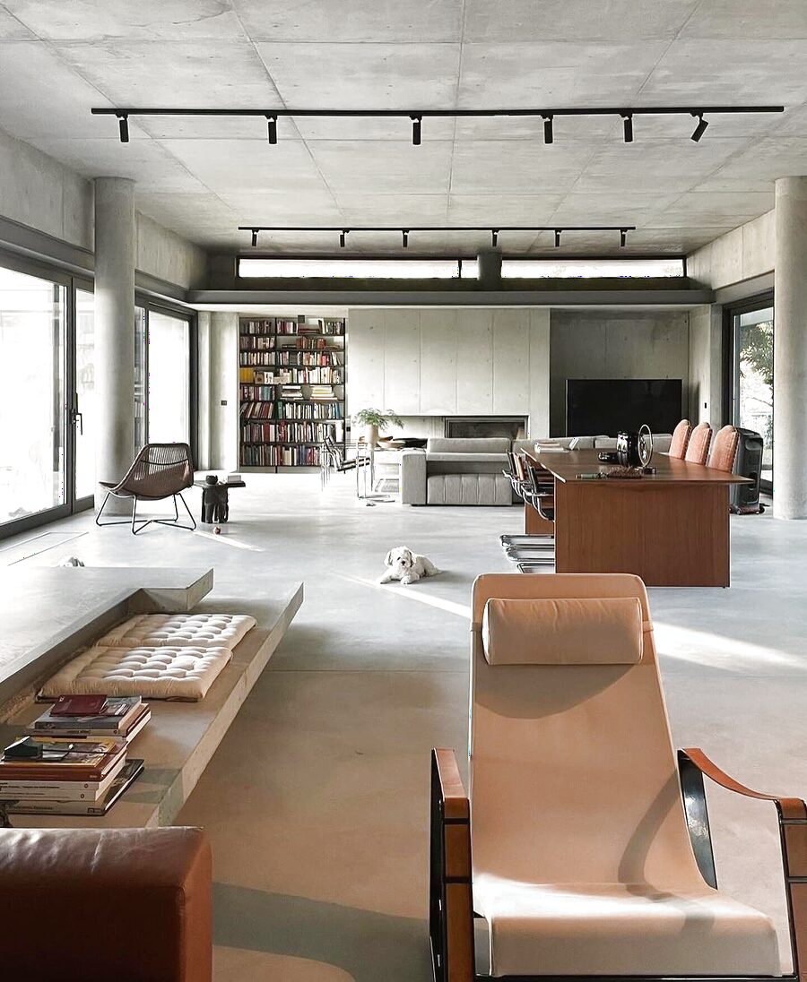 Concrete open-plan loft with track lighting — neo-industrial edge
